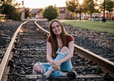 smiling girl on train tracks