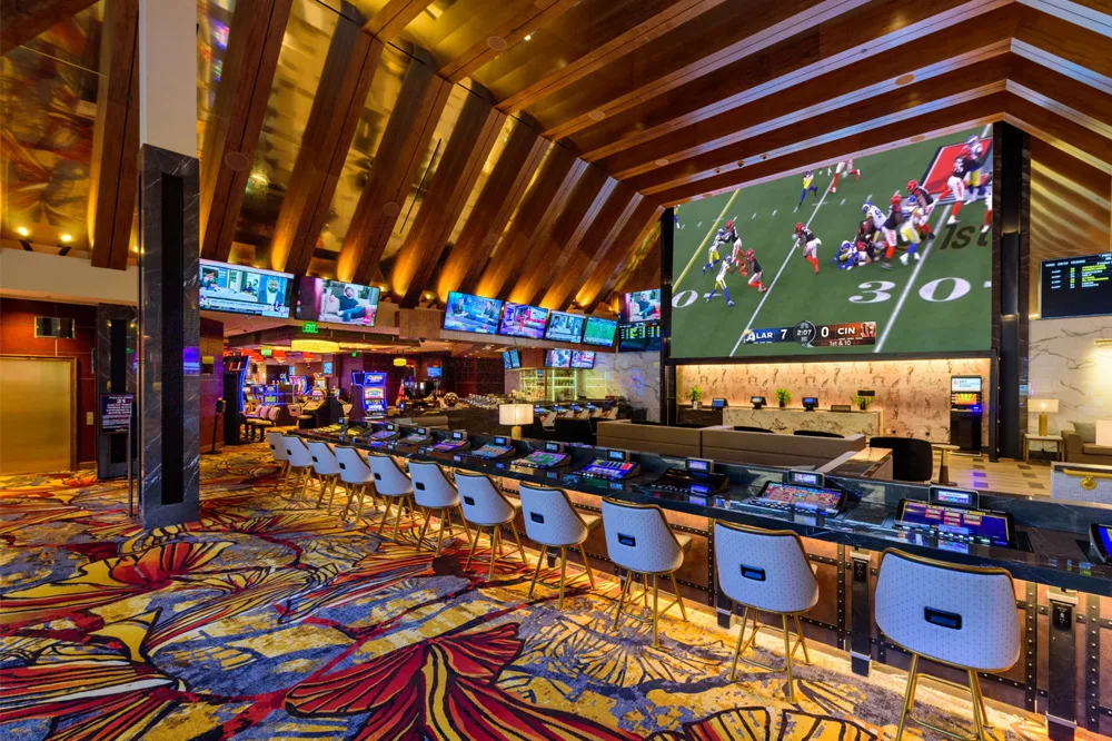 interior of casino with a bar and lots of tvs