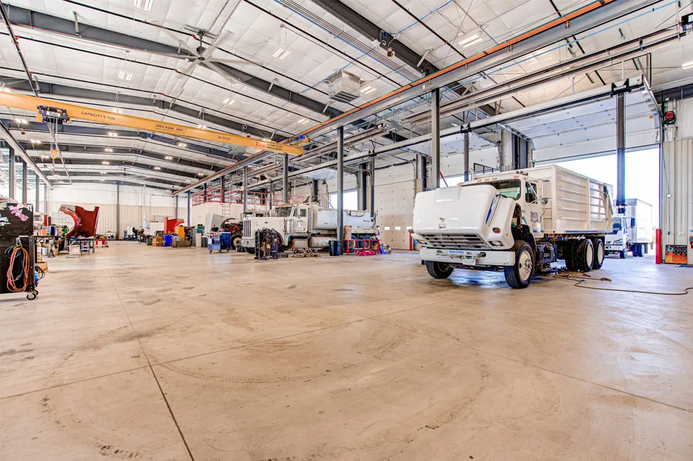 interior of truck warehouse, garbage trucks inside